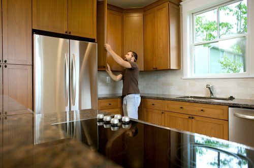 man refacing kitchen cabinets
